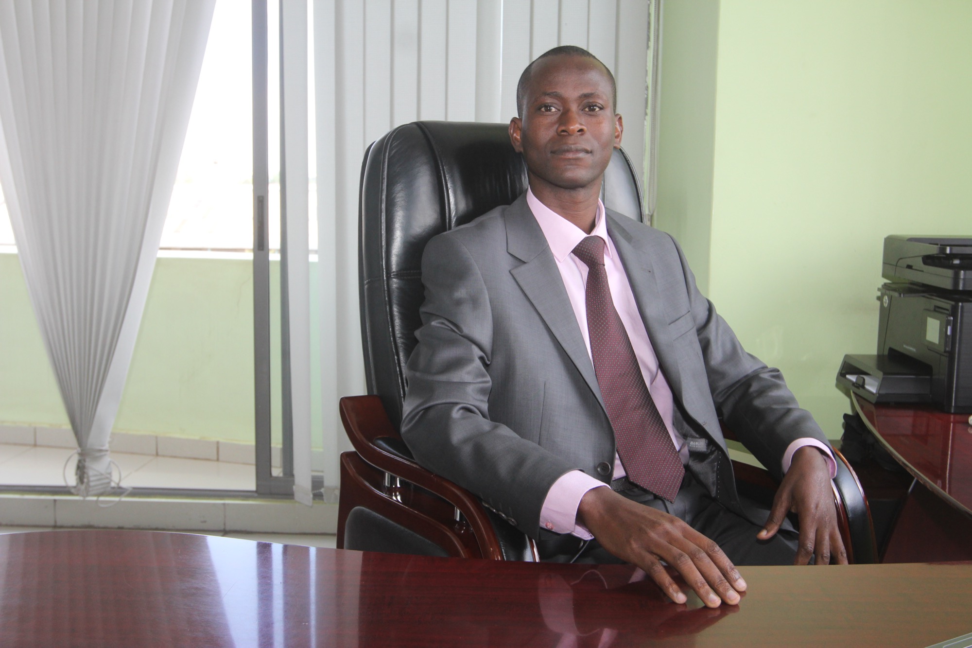 Charles O. Omondi seated at his desk
